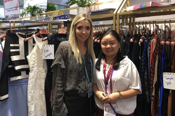 Participating in the Canton Fair Phase III exhibition and taking photos with the buyer of bandage dresses